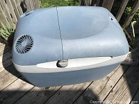 Closed view of the blue and gray Mobicool cooler and warm box with vent on top, showing the overall shape and condition of the unit.