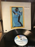 Front cover of Steely Dan's Gaucho album with vinyl record partially out showing MCA Records label.