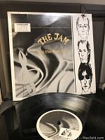 Front cover of The Jam's 'Dig the New Breed' vinyl LP showing artistic design and band portraits
