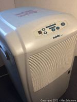 Front angle of Danby Designer dehumidifier showing control panel and ventilation grille.