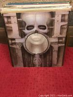 Photo of Emerson, Lake & Palmer album cover showing distinctive biomechanical artwork with a skull-like figure and machinery.