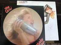 Candy-O picture disc vinyl showing woman holding cocktail shaker, visible corners of sleeve and label text.