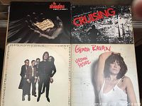 Four records arranged side by side showing covers: The Stranglers Live (Xcert), Cruising soundtrack, Genya Raven Urban Desire, Stiff Records live compilation