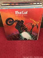 Front view of Meat Loaf 'Bat Out of Hell' vinyl record cover, showing distinctive orange cover with motorcycle illustration.