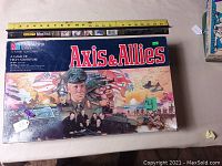 Front of the MB GameMaster Series Axis & Allies vintage board game box showing detailed World War II themed artwork with tank, soldiers, planes, and flag.