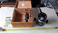 Stanley router with wooden box and manual, ruler showing scale