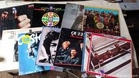 Overview photo of 9 assorted vinyl records including Don McLean, Vanilla Fudge, Queen, Bob Dylan, Elvis Presley, The Beatles, Jimi Hendrix, The Doors, and one unknown artist with a group photo. Covers show wear and vintage style.