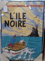 Full view of the L'ile Noire Tintin movie poster showing Tintin in a boat with dog Snowy and island castle in background.