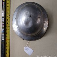Top view of the aluminum WWI M1 parade helmet measuring about 14-15 inches in diameter with visible rivets and area for ventilation or decoration.