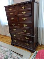Full view of the wooden dresser showing the front and brass handles.