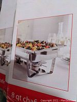 Original box showing photo of one 8 qt stainless steel chafing dish with food in it.