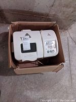 Photo showing white West Bend Homestyle bread and dough maker placed in a cardboard box.