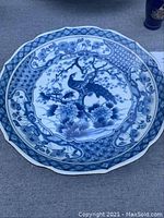 Blue and white platter with pheasant and floral design on top, octagonal rim, showing design details