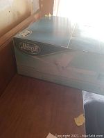 Box containing the Hunter ceiling fan with visible branding and model details on teal-green packaging.