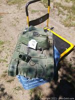 Top and front view of large vintage green plastic WWII toy tank showing detailed molded surface, broken cannon, and radio accessory on top