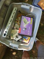 Image of box with Adaptec SCSI Card box, AutoView KVM switch, assorted cables, and computer discs