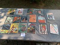 16 Astounding Science Fiction magazines laid flat in protective covers on table outdoors