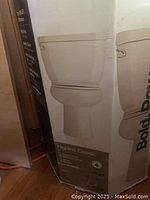 Photo of the boxed Kohler Highline Classic toilet showing product image and model name.