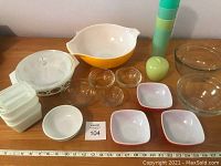 Top-down view of four red square bowls and spare items