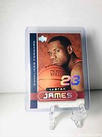 Front of LeBron James rookie card in protective holder, showing player image, team Cavaliers, and holographic number 23.