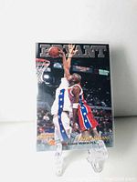 Front of card showing Kobe Bryant in Lower Merion H.S. uniform, embossed BRYANT title and Basketball Rookies logo