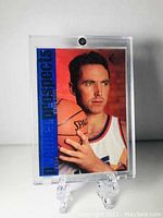 Front of Steve Nash rookie basketball card in protective plastic case, showing player holding basketball with 'Power House Shooters' in blue text at left.