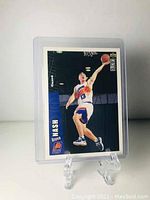Front of Steve Nash rookie basketball card showing action shot of player in Phoenix Suns jersey attempting basketball dunk, card number 310.