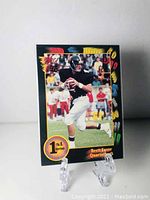 Front photo of Brett Favre rookie card showing him in football gear with 1st Edition badge and colorful border.