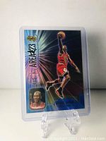 Front view of a holographic Michael Jordan Area 23 insert card from Donruss with blue background, in protective sleeve.