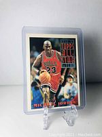 Front of the Michael Jordan 1992-93 Topps All Star basketball card in protective case, showing full card and stand.