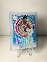 Front view of Mystique Jason Tatum basketball card in protective plastic case on display stand.