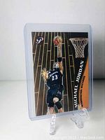 Front of Michael Jordan basketball insert card in protective sleeve on a display stand showing him dunking in Wizards uniform