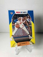 Front of the RJ Barrett basketball card showing player in New York Knicks uniform with yellow parallel color design