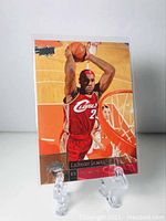 Front view of 2009-10 Upper Deck LeBron James basketball card featuring action shot of LeBron James dunking in Cleveland Cavaliers jersey.