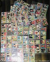 Multiple plastic binder pages filled with 1976 Topps baseball cards showing many players across different teams.