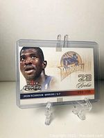 Front view of Jason Richardson basketball rookie trading card in protective case showing player image and team logo.