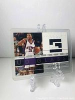 Front angled photo of the basketball card featuring Shawn Marion in Phoenix Suns uniform with embedded jersey patch.