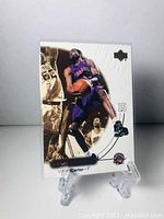 Front side of Vince Carter Upper Deck Ovation basketball card showing action shot and design.