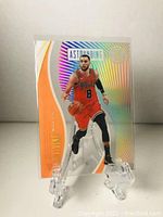 Front view of Zach LaVine Panini Astounding card showing holographic design, player image, and team colors.