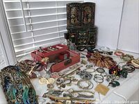 Overall lot with two jewelry boxes and assorted jewelry laid out