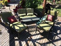 Full set view on deck showing loveseat, chairs, ottomans and coffee table