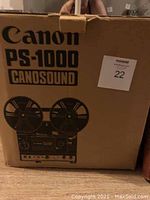 Original cardboard box of Canon PS-1000 Canosound showing model name and graphics of the tape recorder.