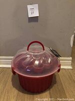 Red large cupcakes carrier and holder closed, clear domed lid with red handle on top and tags attached