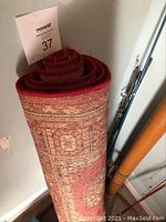 Rolled view of the wine red carpet showing the side pattern and rolled shape for storage.