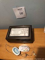 Wooden music box with framed baptism sentiment plaque and porcelain baby trinket box with rosary