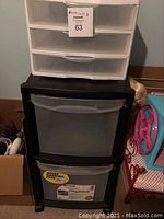 Two plastic drawer storage units stacked, Sterilite 3 drawer organizer on top and a black Homs 2 drawer wheeled unit below.