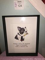 Full view of black framed wall art showing French Bulldog with French fry and caption.