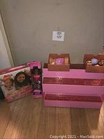 Overall view showing Best Friends Sleepover board game box, Lilly doll packaging, and pink and brown LOL doll display with dolls inside