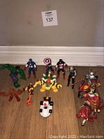 Nine assorted action figures including knights on horses, Nintendo characters, and Marvel superheroes.