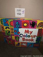 Four colorful preschool books stacked, visible covers include My Colour Book and parts of others with bright illustrations